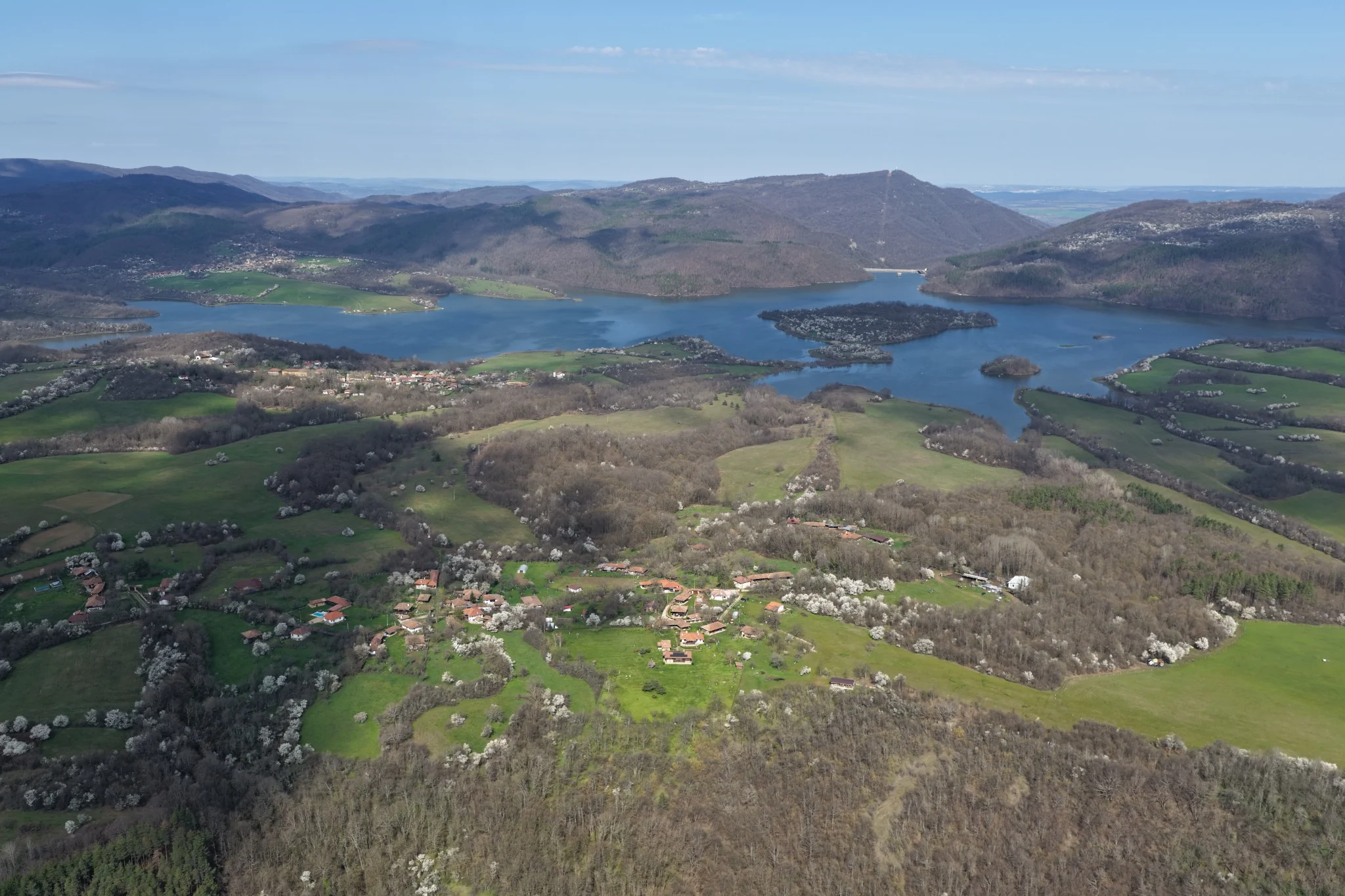 Въздушна панорама към язовир и зелени хълмове